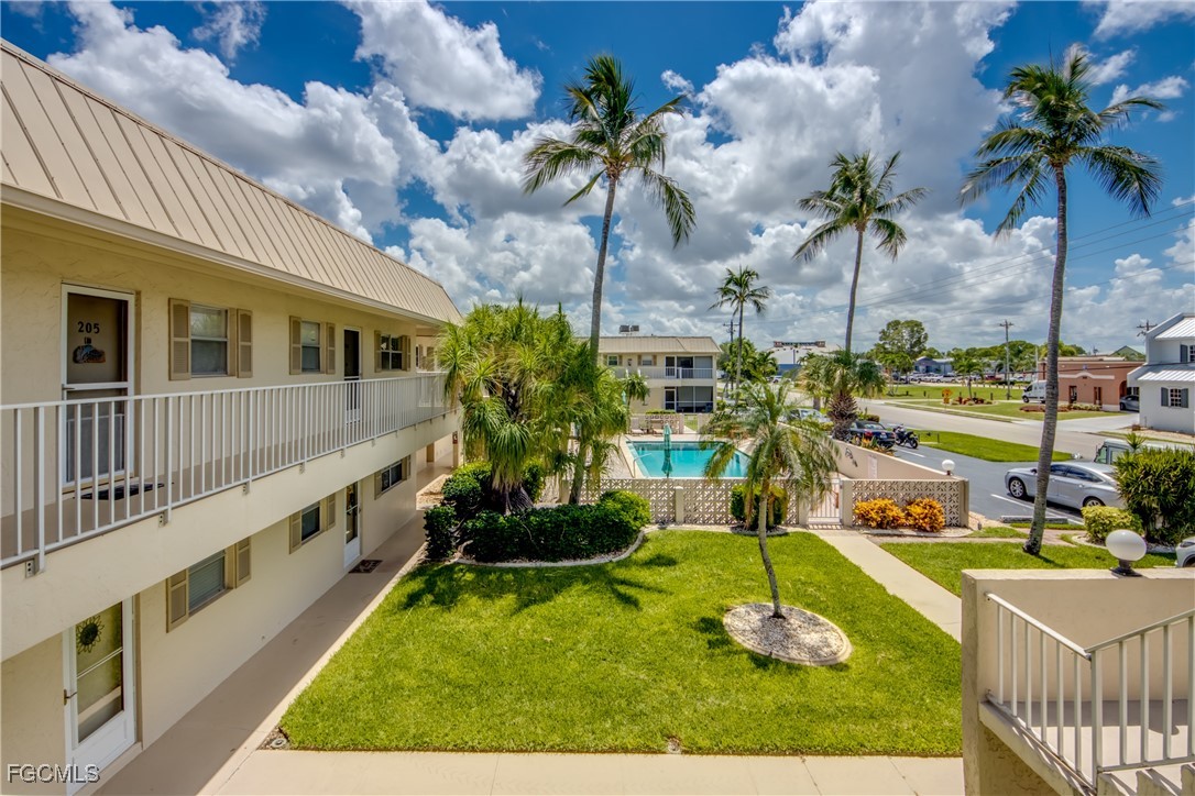 909 Southeast 46th Lane, Unit 202 Cape Coral, FL 33904 - Photo 3 of 38 a view of a house with swimming pool and sitting area