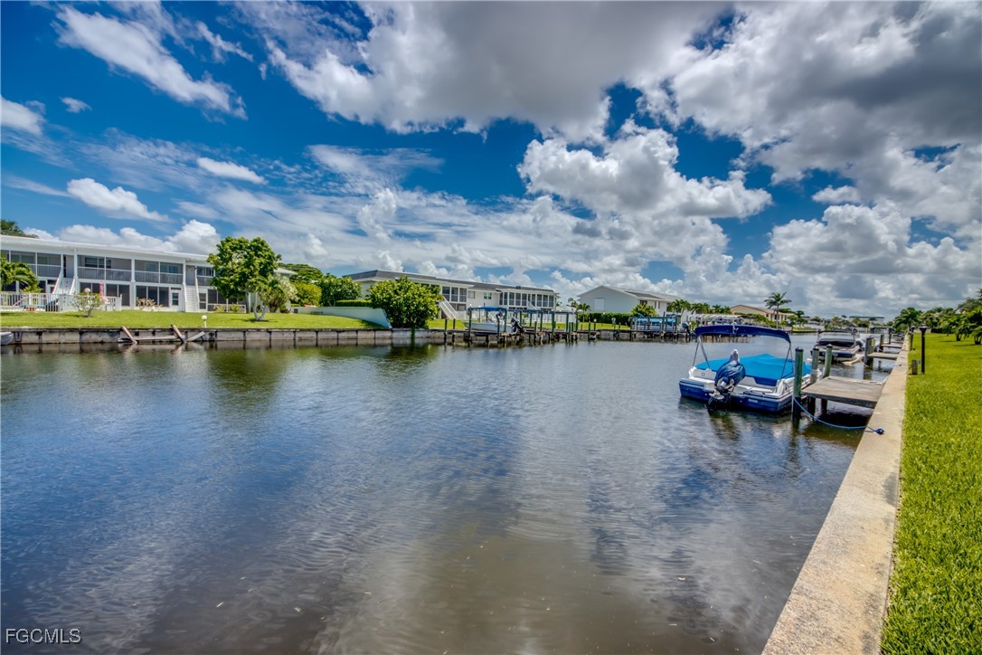 909 Southeast 46th Lane, Unit 202 Cape Coral, FL 33904 - Photo 32 of 38 a view of a lake with outdoor space