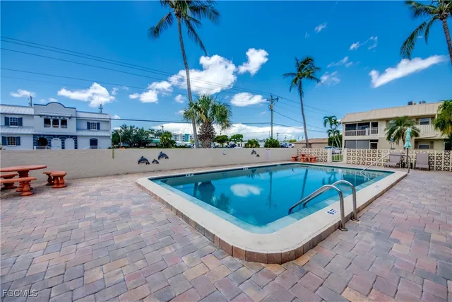 a swimming pool with outdoor seating and yard