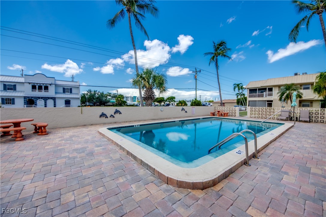 909 Southeast 46th Lane, Unit 202 Cape Coral, FL 33904 - Photo 34 of 38 a room with pool table and a chandelier