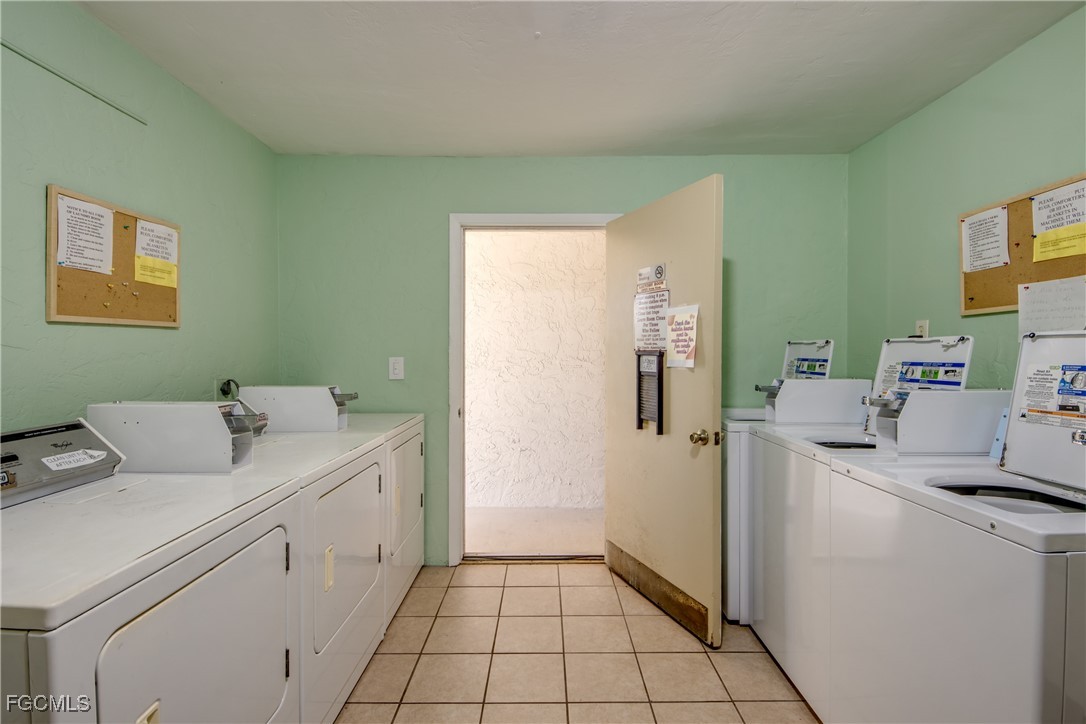 909 Southeast 46th Lane, Unit 202 Cape Coral, FL 33904 - Photo 36 of 38 a utility room with cabinets washer and dryer