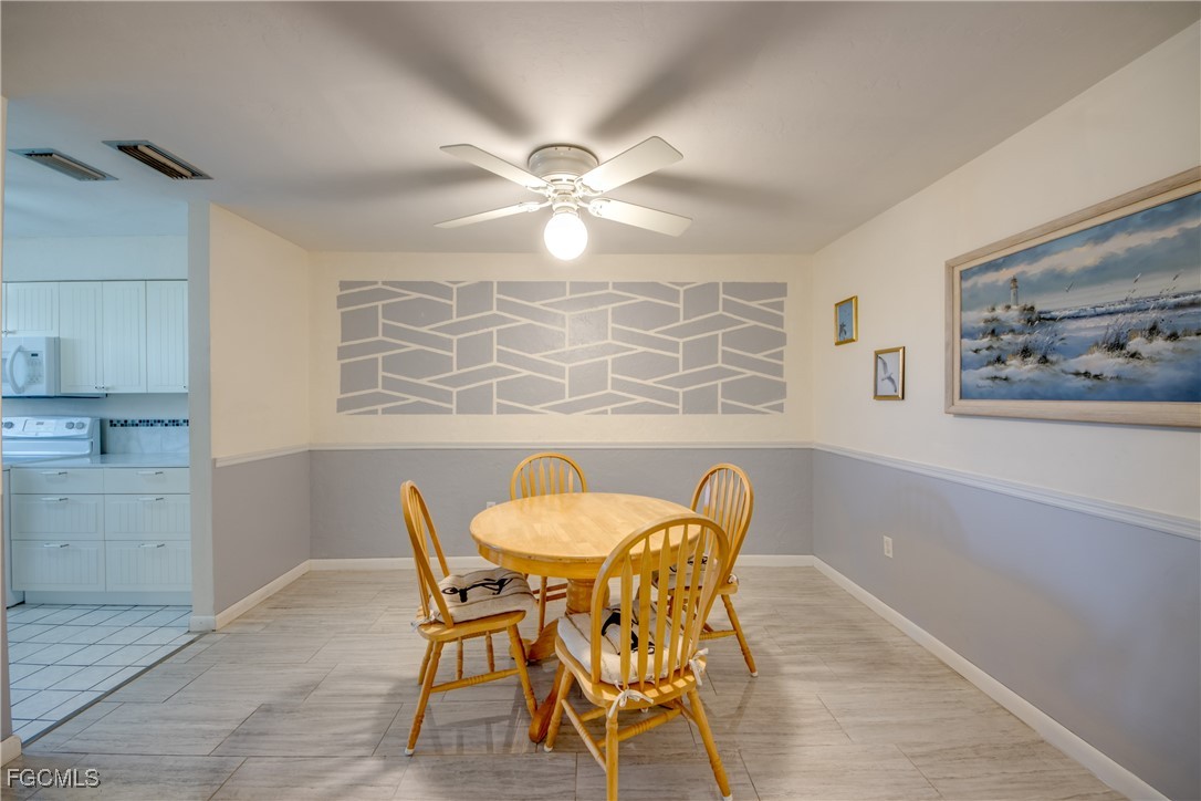 909 Southeast 46th Lane, Unit 202 Cape Coral, FL 33904 - Photo 10 of 38 a dining room with furniture and window