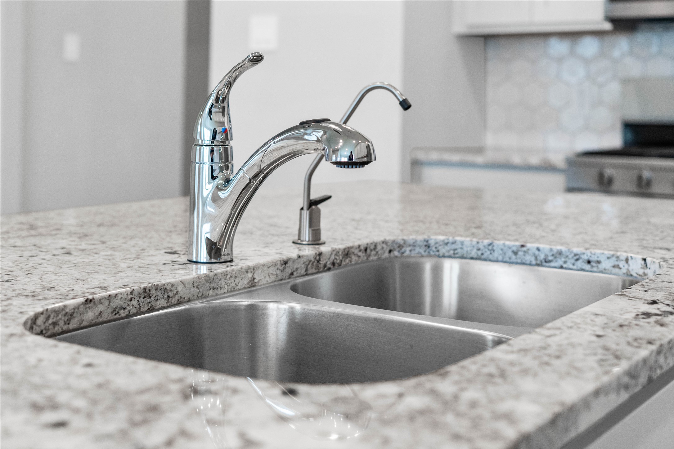 19645 Montgomery Rdg Way Montgomery, TX 77316 - Photo 16 of 41 The kitchen features a stainless steel 50/50 undermount sink and a Moen Integra chrome kitchen faucet with DuPure water filtration system.