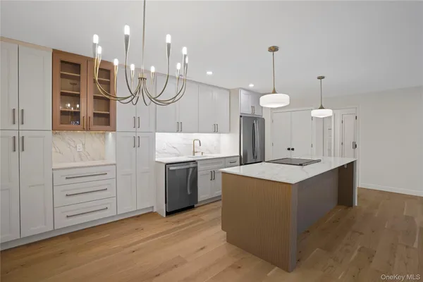 a large kitchen with a lot of counter space and wooden floor