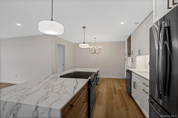a kitchen with kitchen island a counter space a sink and appliances