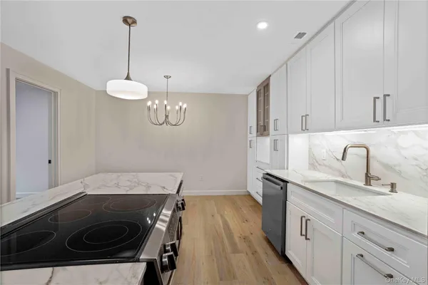a kitchen with a sink stove and cabinets