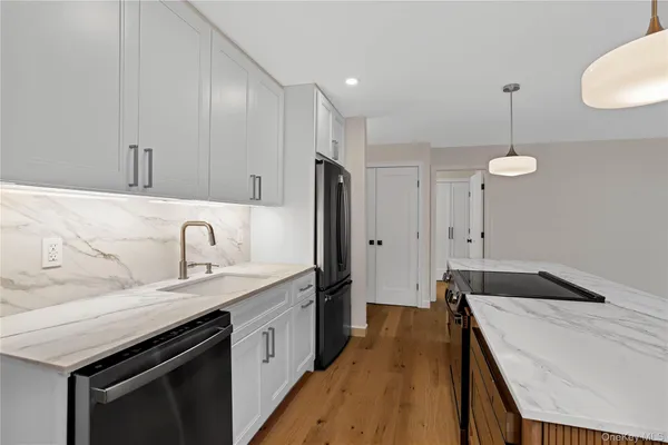 a kitchen with a sink stove and refrigerator