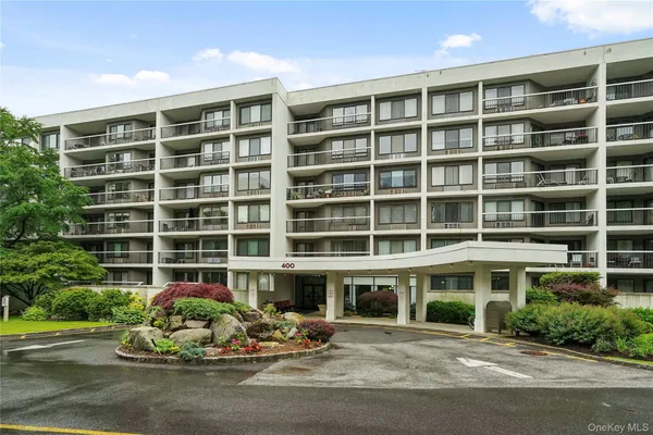 a front view of a building with a garden
