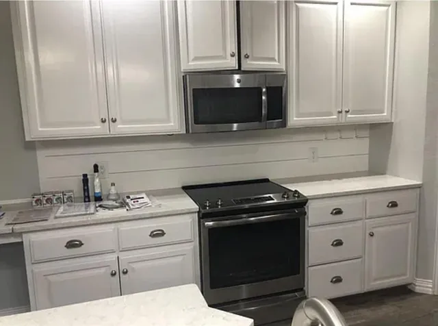 a kitchen with stainless steel appliances granite countertop a refrigerator a sink a stove and island