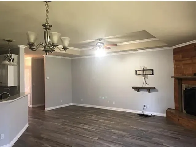 a kitchen with granite countertop white cabinets and stainless steel appliances