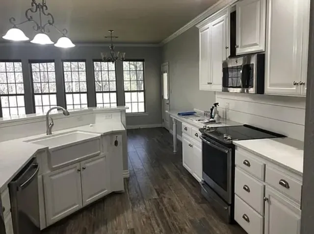 a room with a sink a mirror and gym equipment