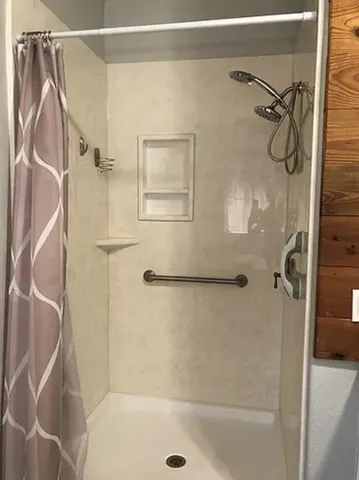 a bathroom with a glass shower door