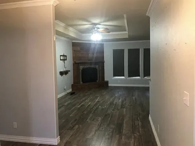 a view of a hallway with wooden floor and a fireplace