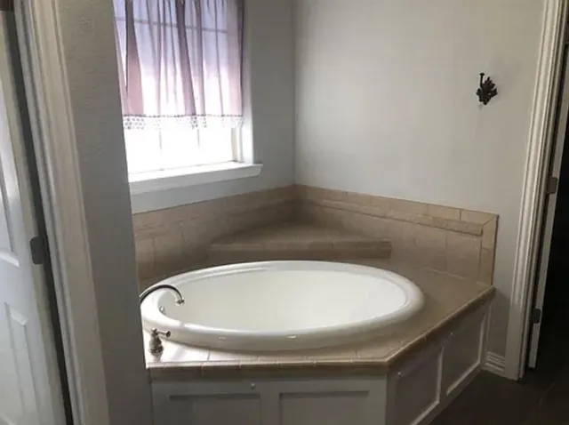 a sink sitting in a bathroom next to a window
