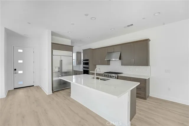 a view of a kitchen with a sink stainless steel appliances and cabinets