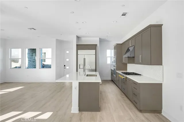 a view of a kitchen with a sink and cabinets