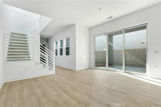 a view of a big room with windows and stairs
