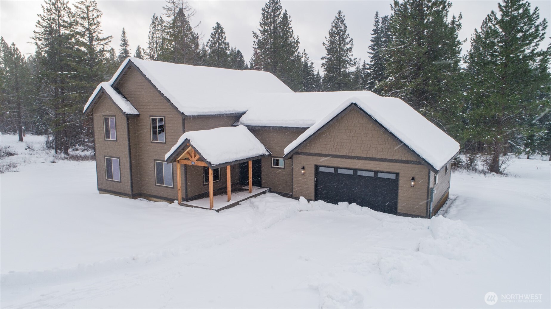 a view of a house with a yard covered in snow