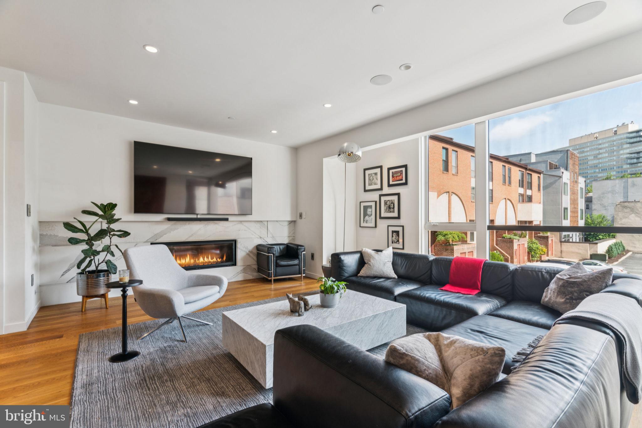 206 North 22nd Street, Unit E Philadelphia, PA 19103 - Photo 11 of 50 a living room with furniture and a flat screen tv