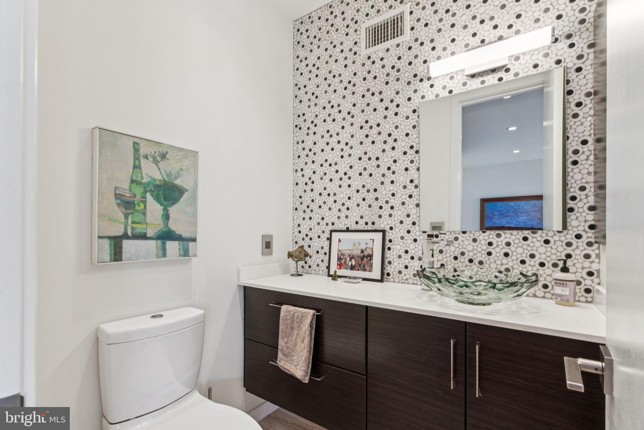 206 North 22nd Street, Unit E Philadelphia, PA 19103 - Photo 14 of 50 a bathroom with a sink a toilet and mirror