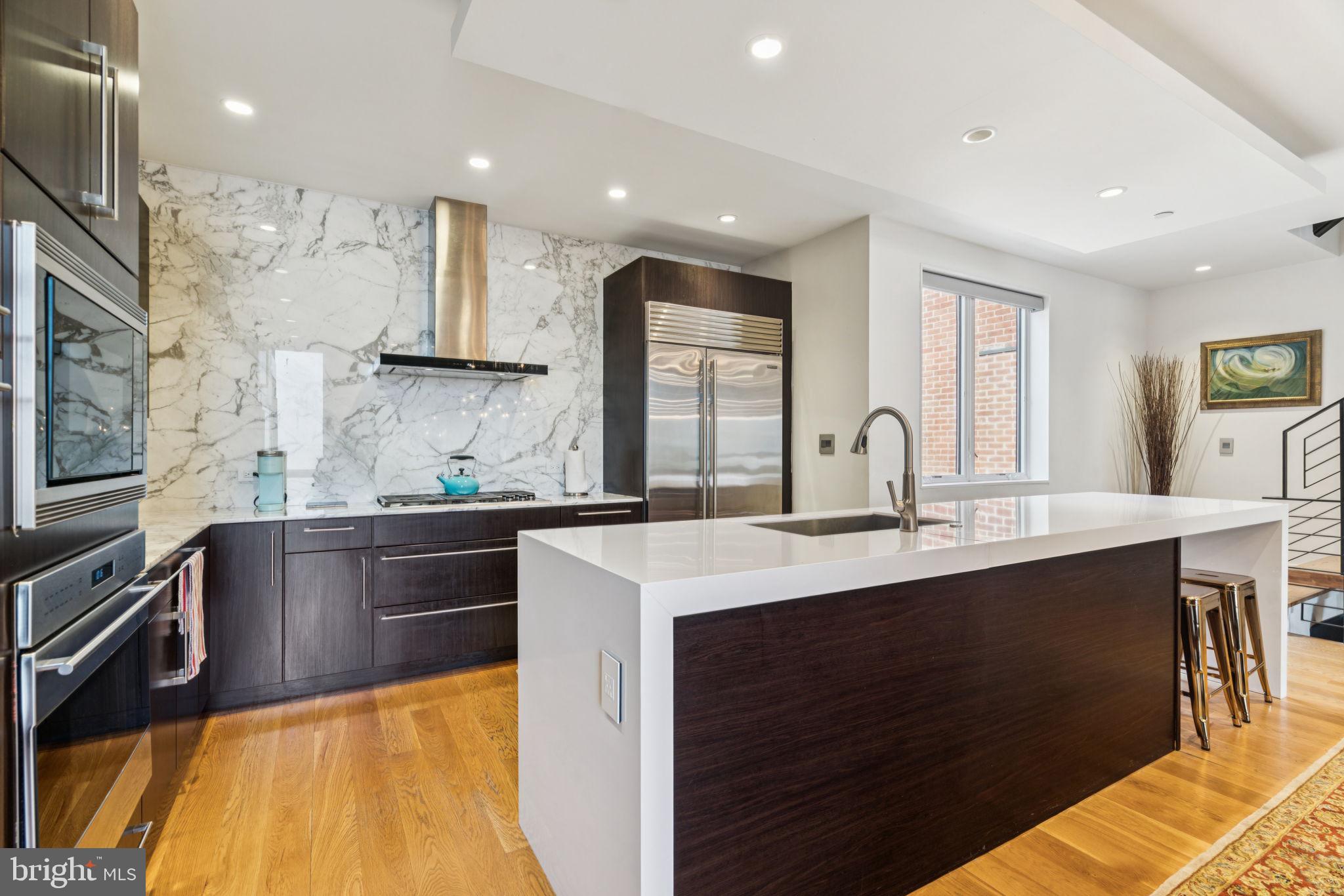 206 North 22nd Street, Unit E Philadelphia, PA 19103 - Photo 18 of 50 a kitchen with stainless steel appliances granite countertop a sink and cabinets
