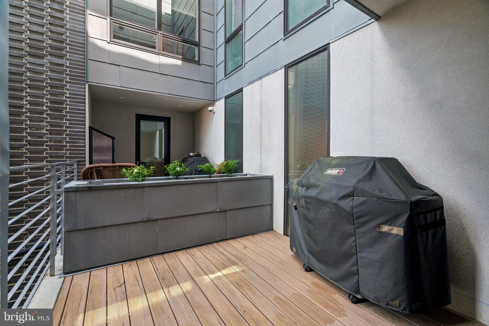 206 North 22nd Street, Unit E Philadelphia, PA 19103 - Photo 22 of 50 a view of balcony with wooden floor and potted plants