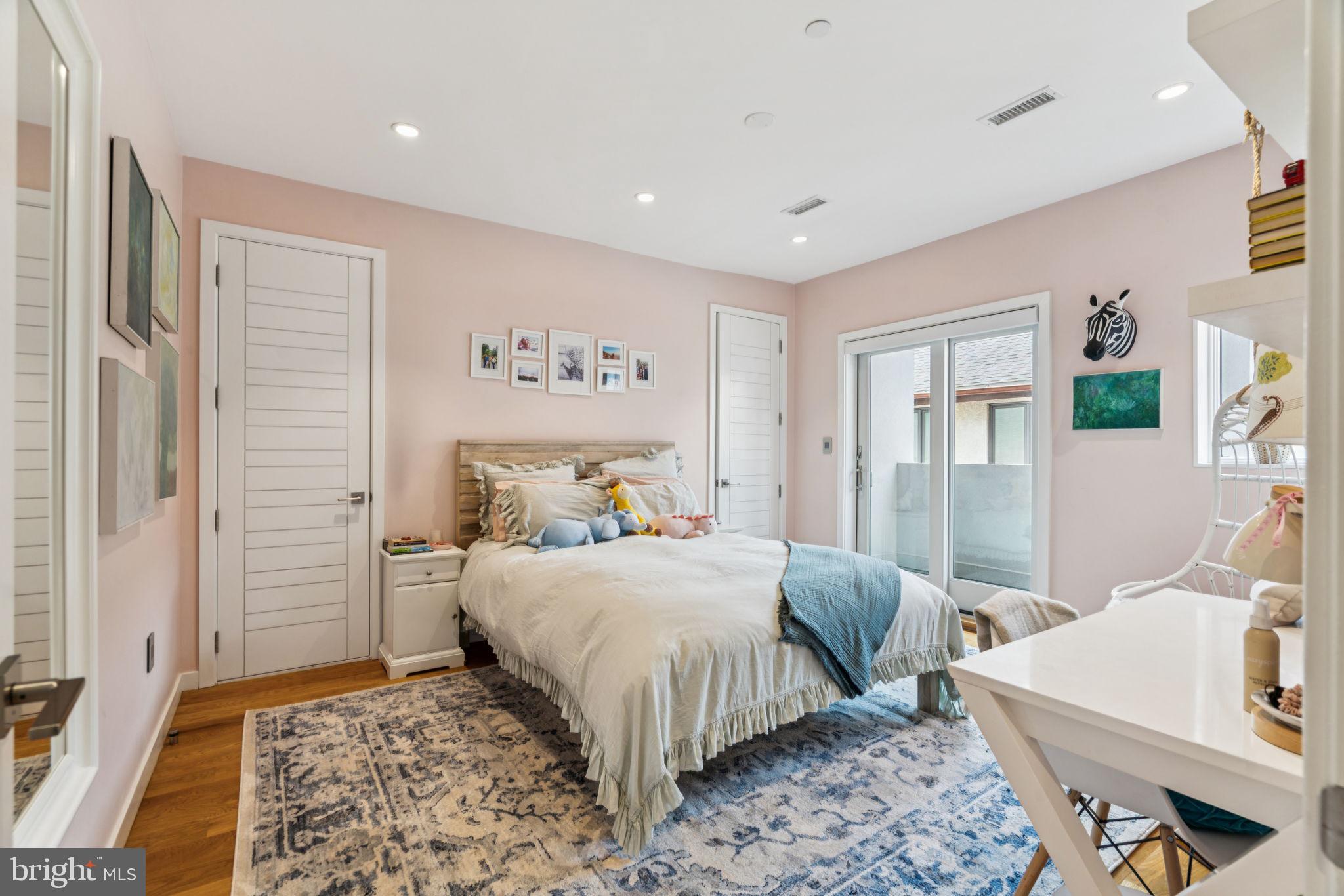 206 North 22nd Street, Unit E Philadelphia, PA 19103 - Photo 24 of 50 a bedroom with a bed and a table in it