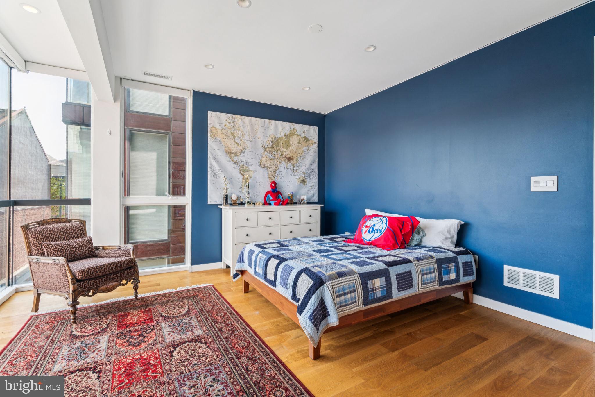 206 North 22nd Street, Unit E Philadelphia, PA 19103 - Photo 28 of 50 a bedroom with a bed and a couch