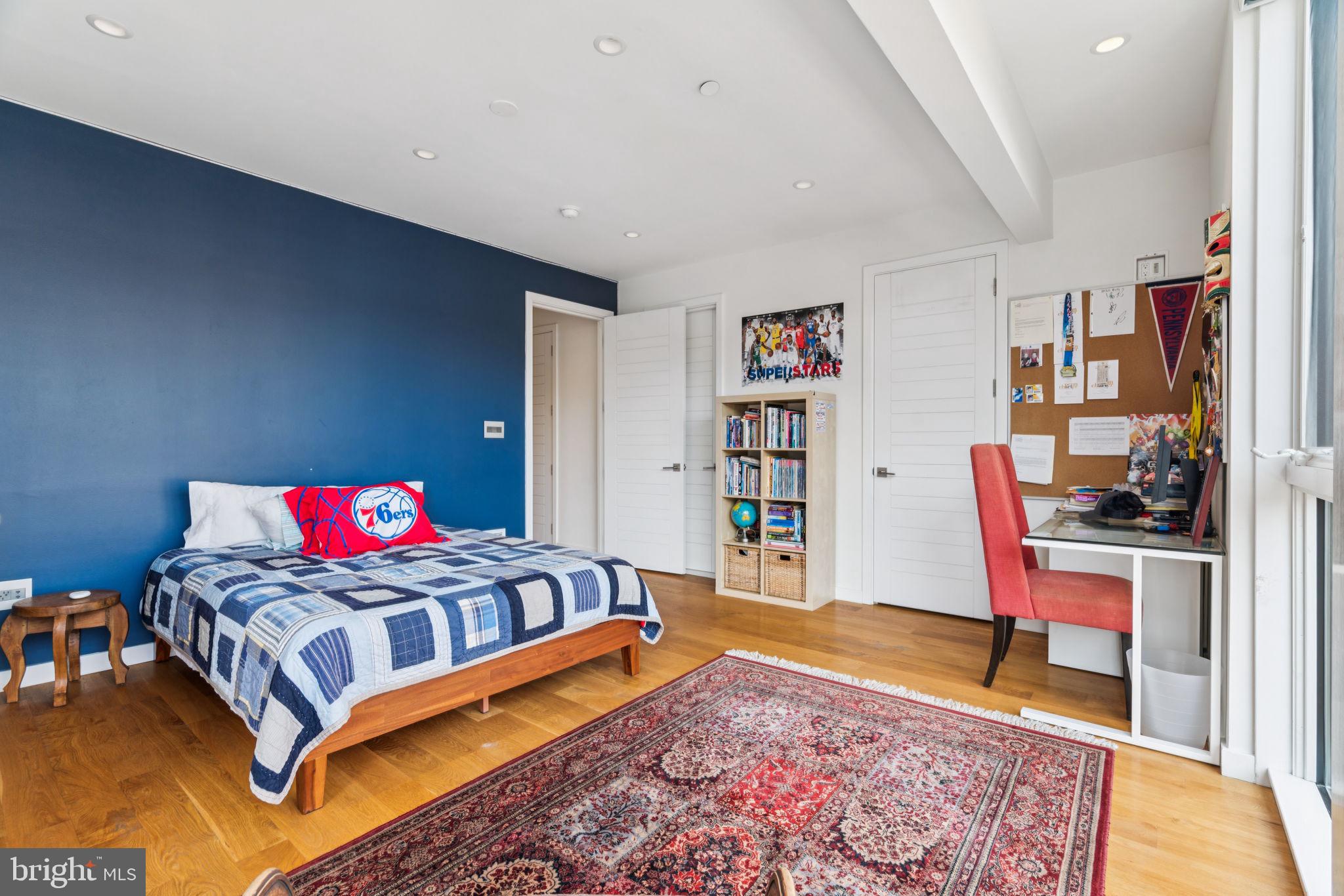 206 North 22nd Street, Unit E Philadelphia, PA 19103 - Photo 29 of 50 a bedroom with a bed and a book shelf