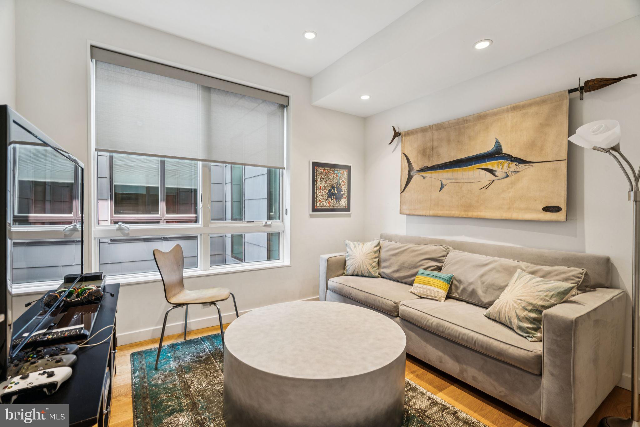 206 North 22nd Street, Unit E Philadelphia, PA 19103 - Photo 31 of 50 a living room with furniture and a floor to ceiling window