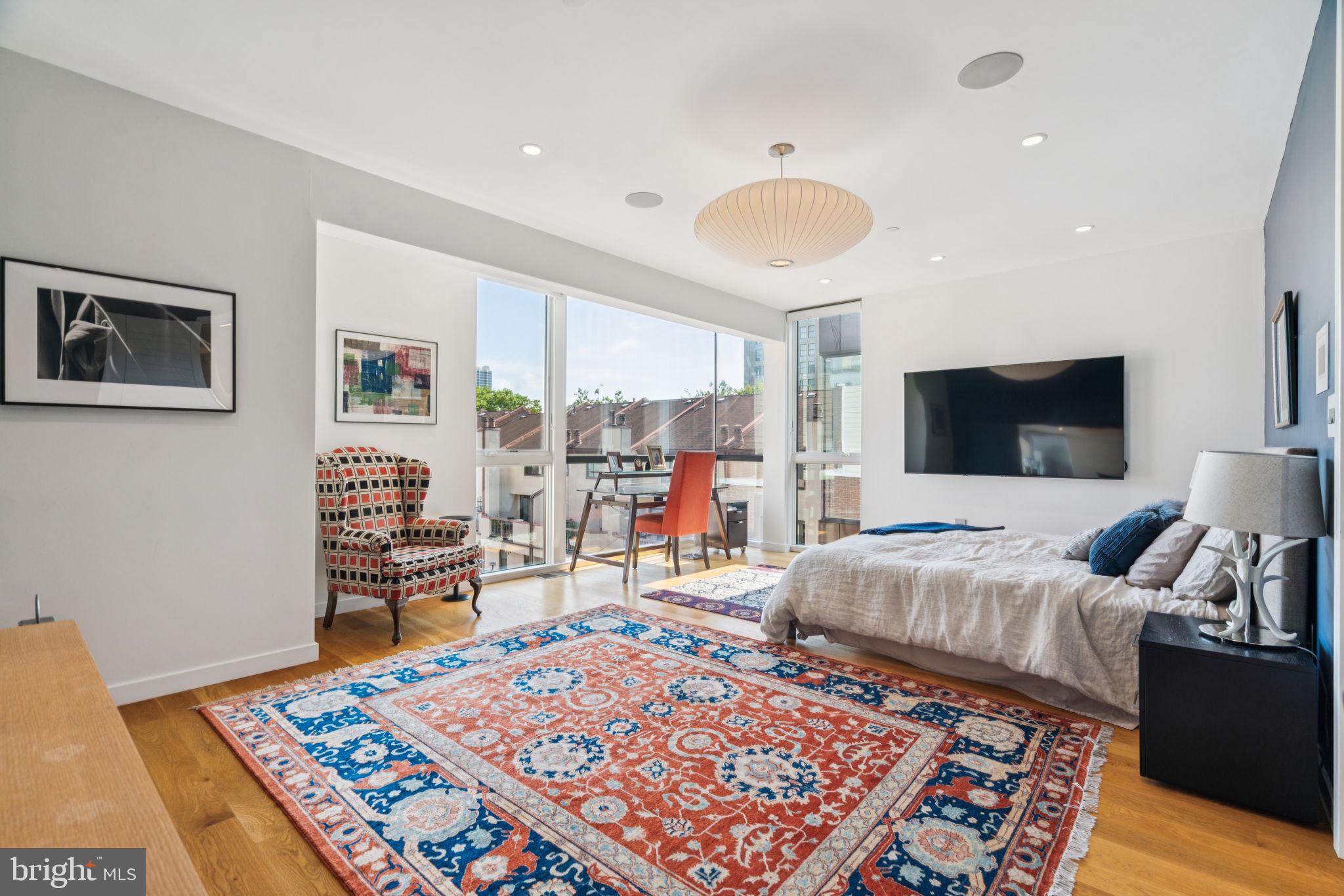 206 North 22nd Street, Unit E Philadelphia, PA 19103 - Photo 34 of 50 a living room with furniture and a flat screen tv