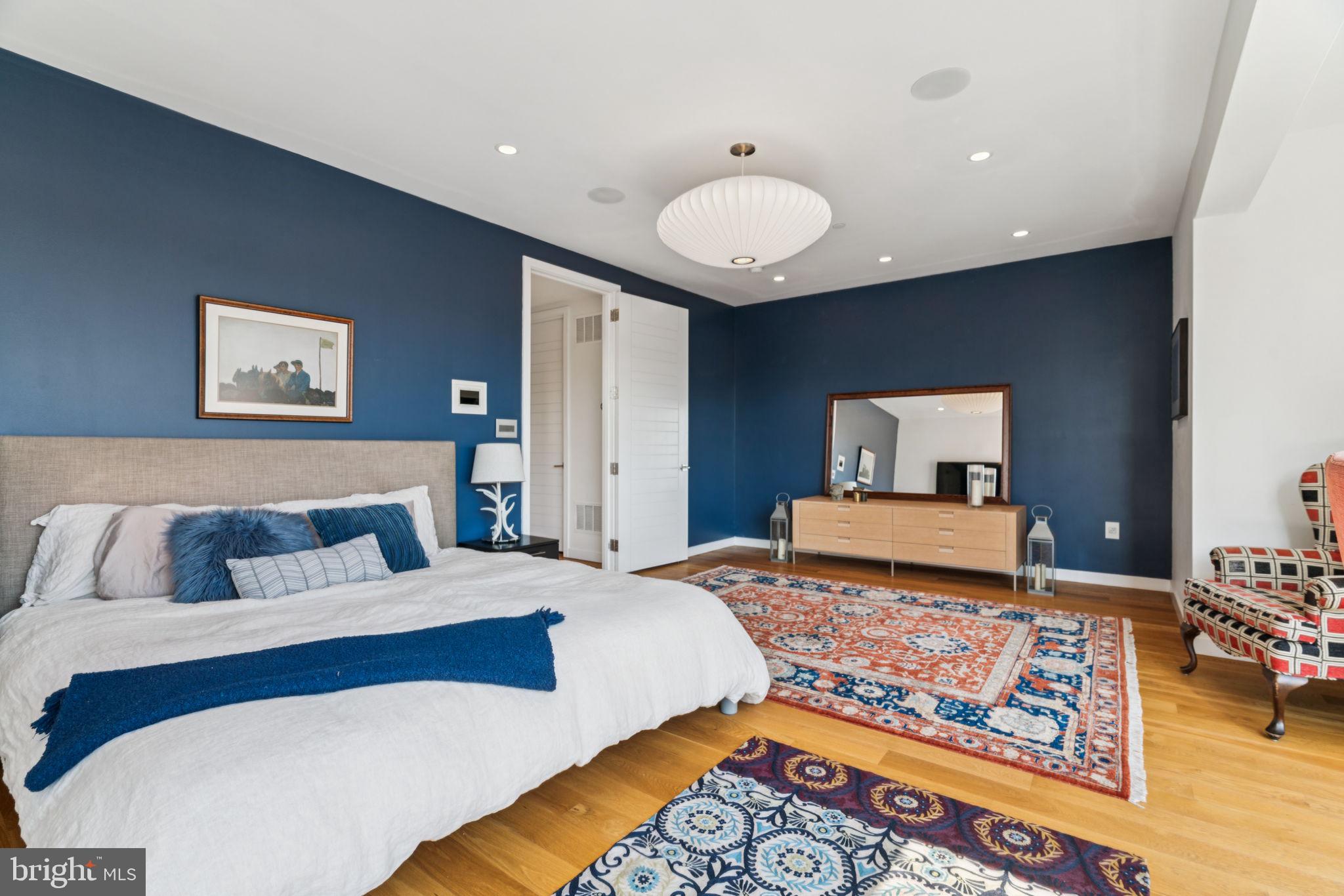 206 North 22nd Street, Unit E Philadelphia, PA 19103 - Photo 36 of 50 a bedroom with a bed and wooden floor