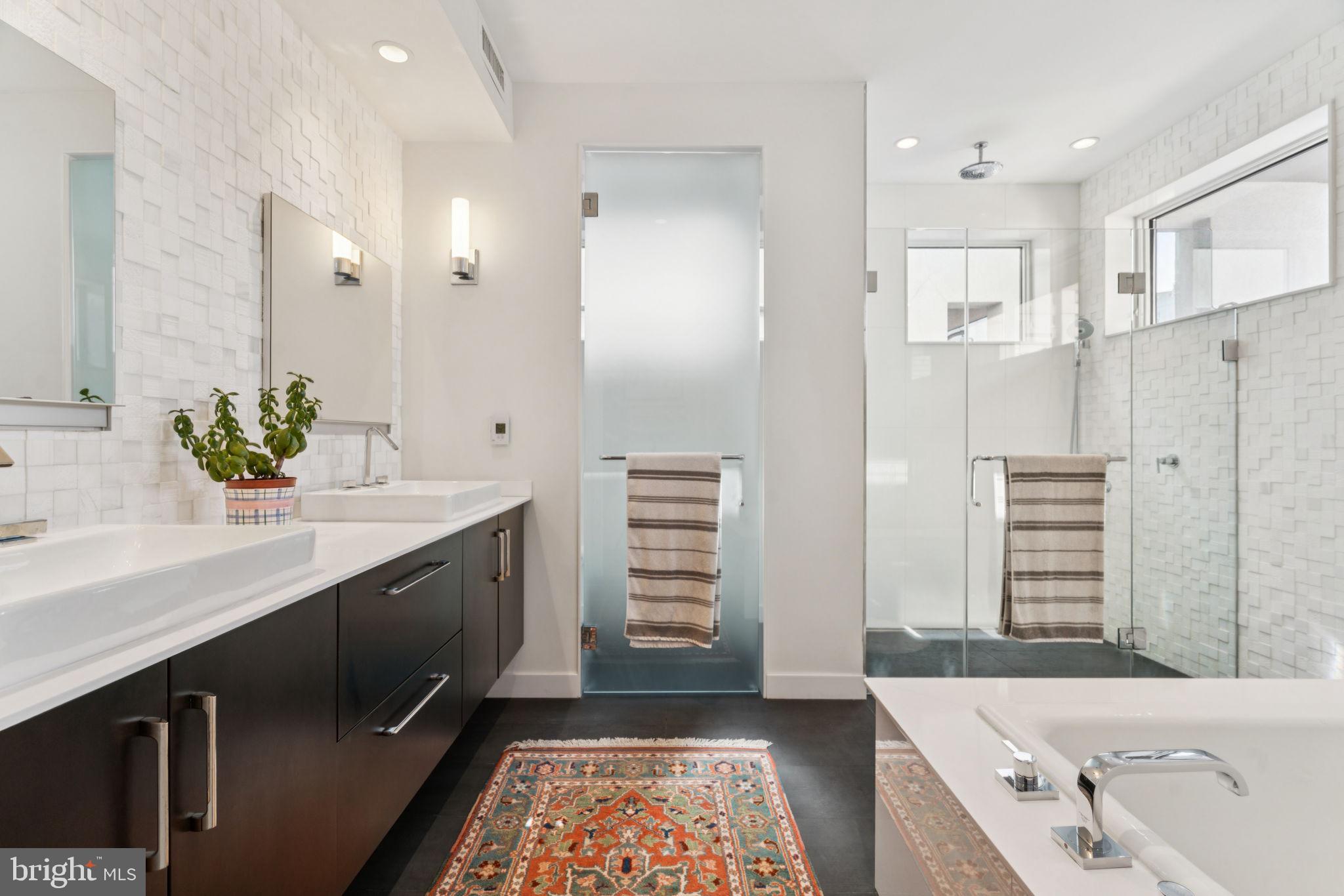 206 North 22nd Street, Unit E Philadelphia, PA 19103 - Photo 37 of 50 a spacious bathroom with a double vanity sink a mirror and a bathtub