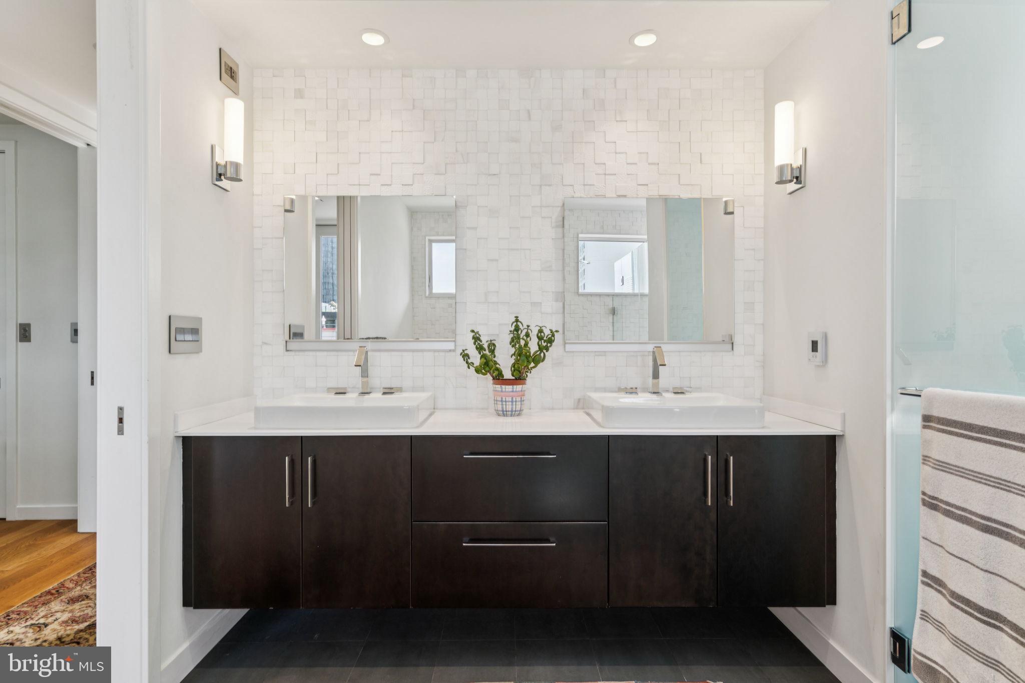 206 North 22nd Street, Unit E Philadelphia, PA 19103 - Photo 38 of 50 a bathroom with double sink and mirror
