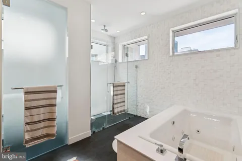 a bathroom with a bathtub and a shower