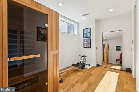 a view of a bedroom with a bed and wooden floor