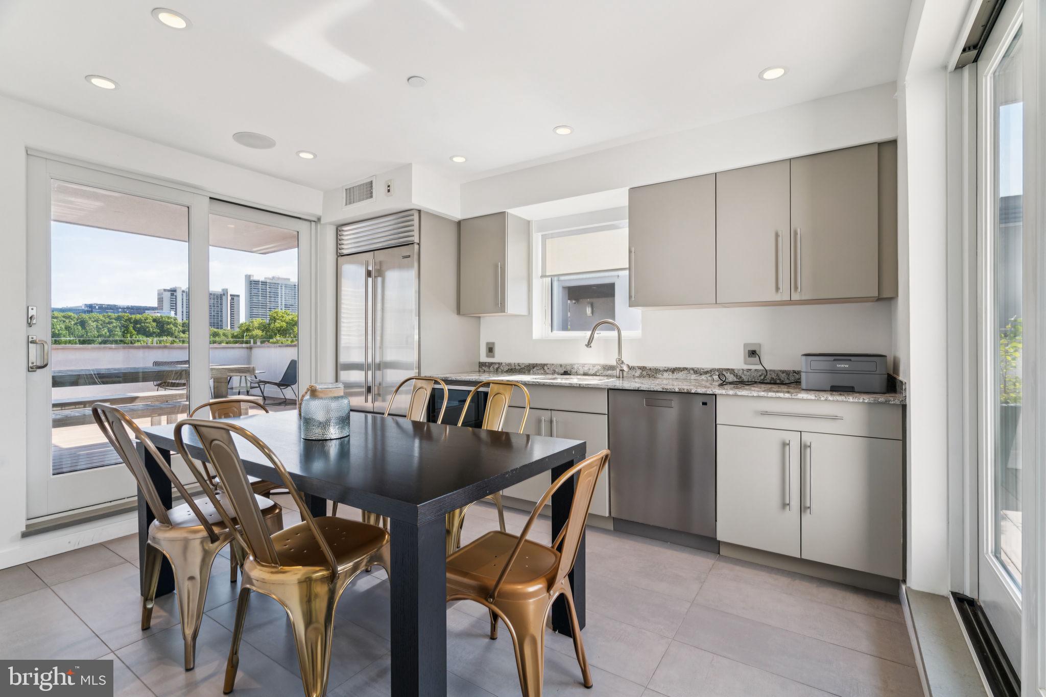206 North 22nd Street, Unit E Philadelphia, PA 19103 - Photo 45 of 50 a kitchen with a table chairs sink and cabinets