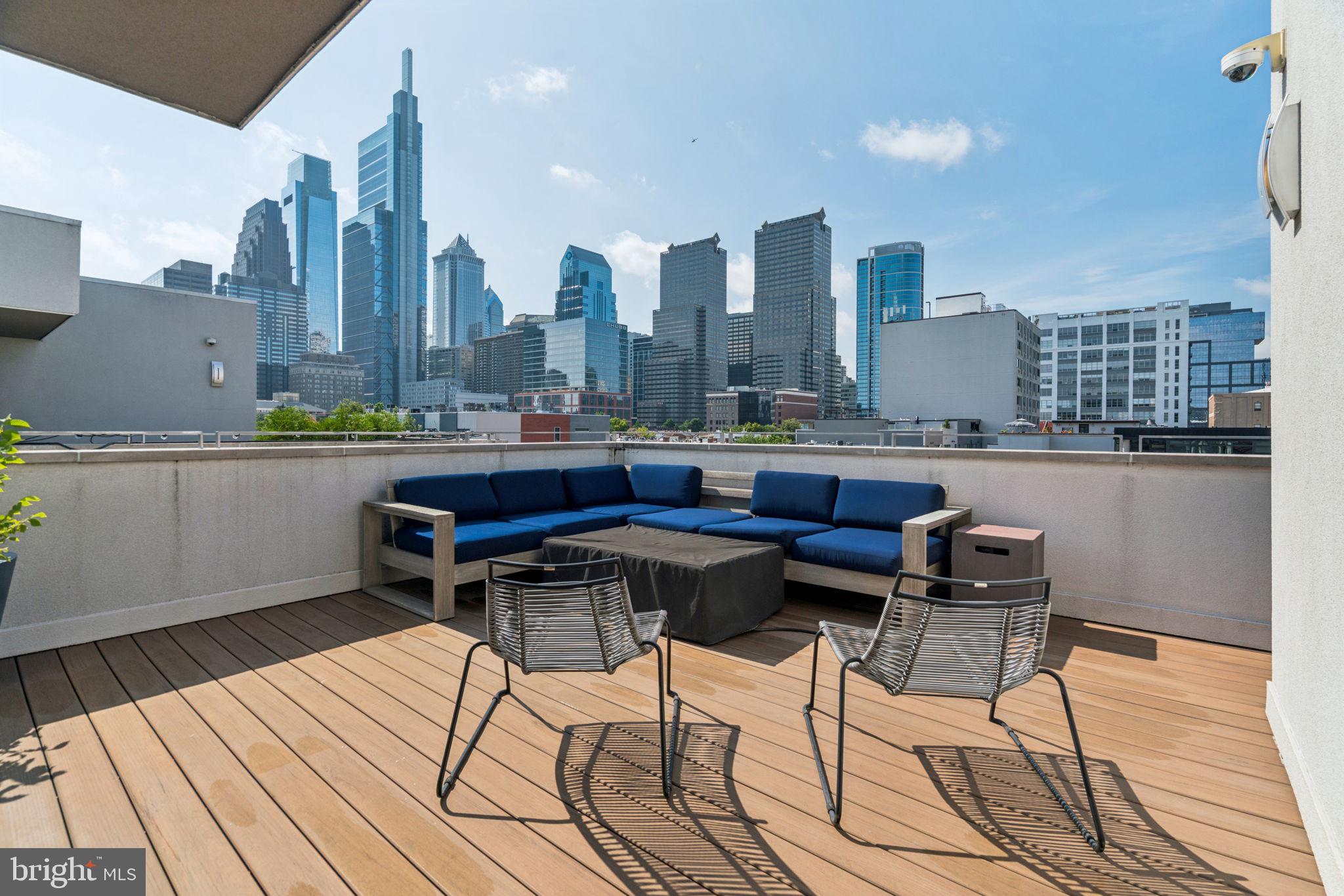 206 North 22nd Street, Unit E Philadelphia, PA 19103 - Photo 47 of 50 a terrace with wooden floor table and chairs