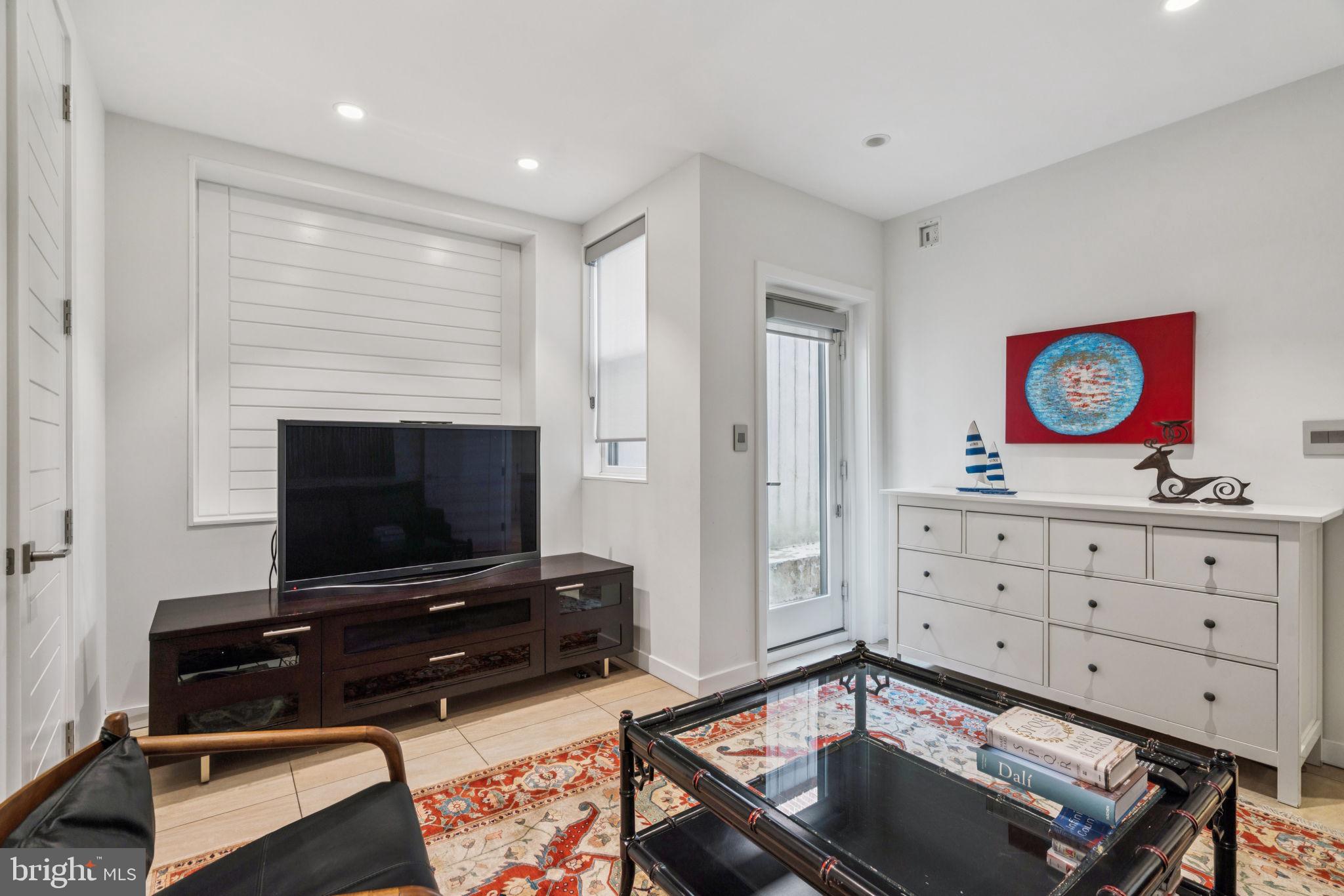 206 North 22nd Street, Unit E Philadelphia, PA 19103 - Photo 6 of 50 a living room with furniture and a flat screen tv