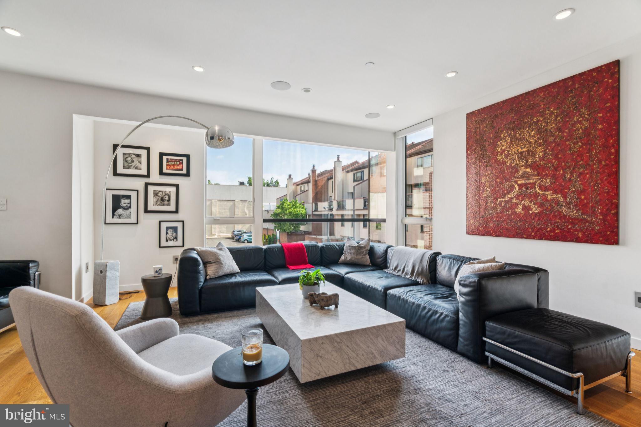 206 North 22nd Street, Unit E Philadelphia, PA 19103 - Photo 9 of 50 a living room with furniture a rug and a wall painting