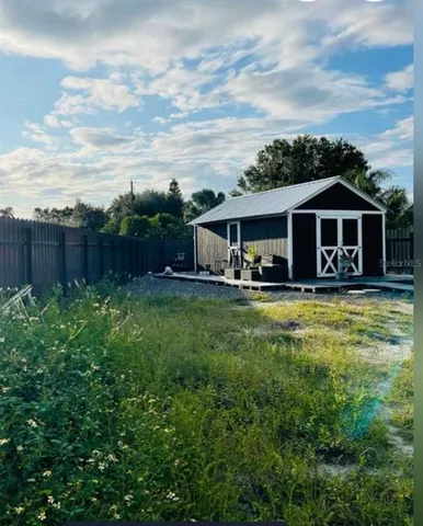 a front view of house with yard and swimming pool