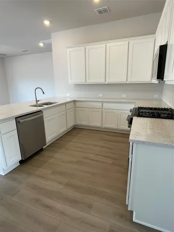 a kitchen with sink cabinets and microwave