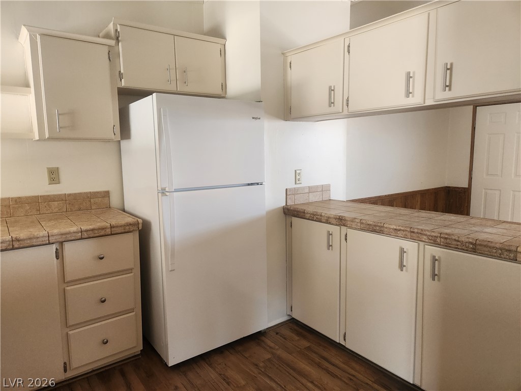 3189 Del Monte Street Laughlin, NV 89029 - Photo 9 of 32 Functional kitchen offers ample storage and a pass-through counter for versatile living.