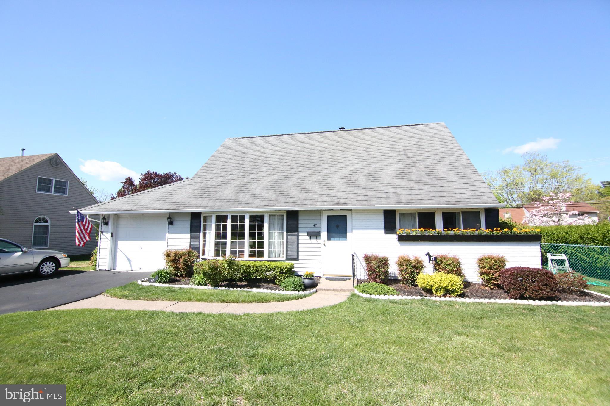a front view of house with yard and outdoor seating