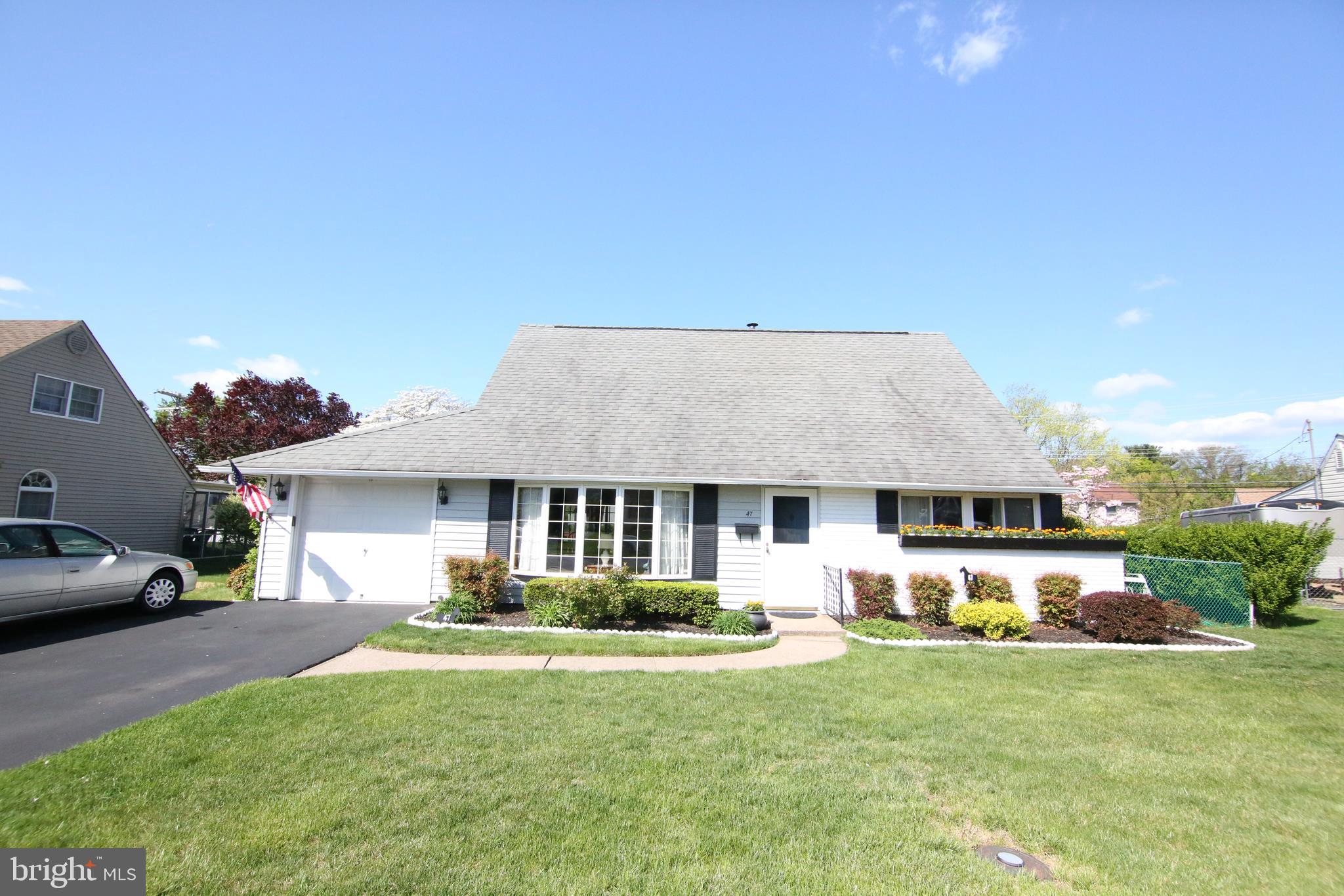 47 Trellis Road Levittown, PA 19056 - Photo 2 of 34 a front view of a house with a yard and garage