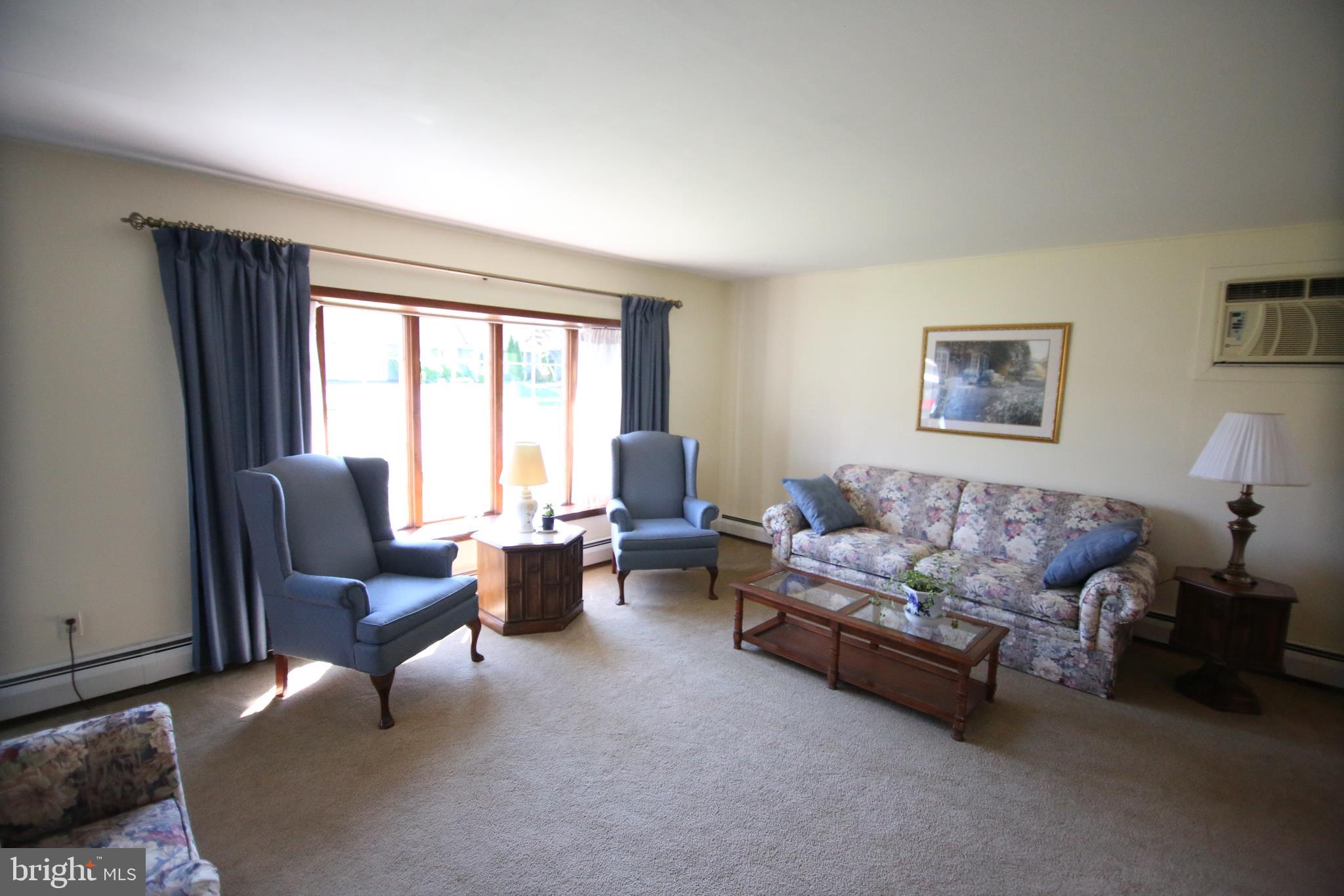 47 Trellis Road Levittown, PA 19056 - Photo 12 of 34 a living room with furniture and large windows