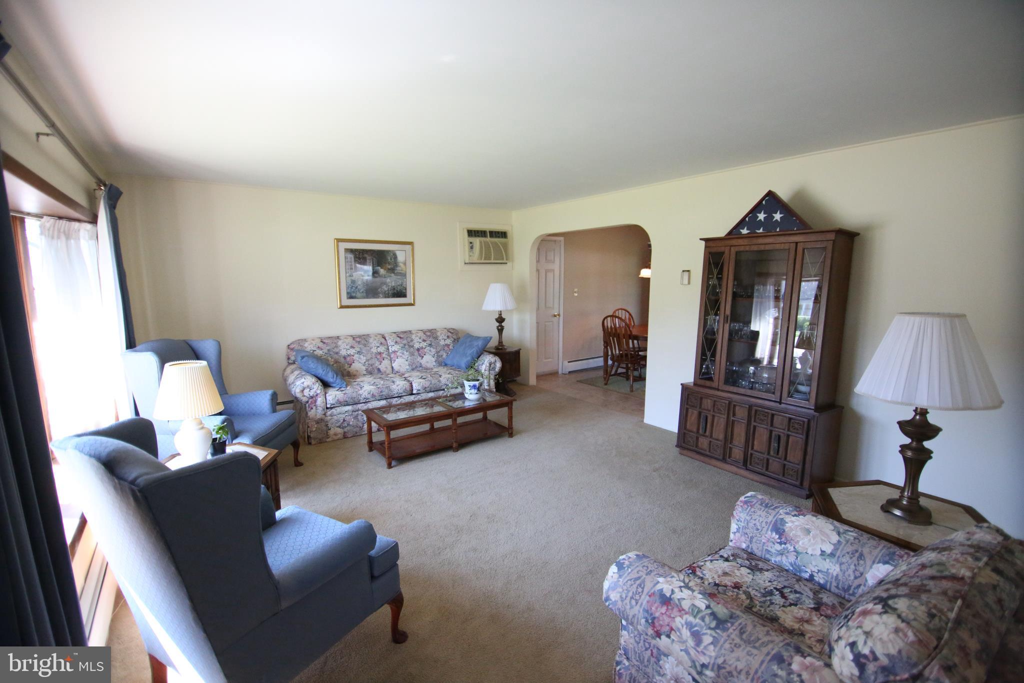 47 Trellis Road Levittown, PA 19056 - Photo 13 of 34 a living room with furniture hard wood floor and a lamp