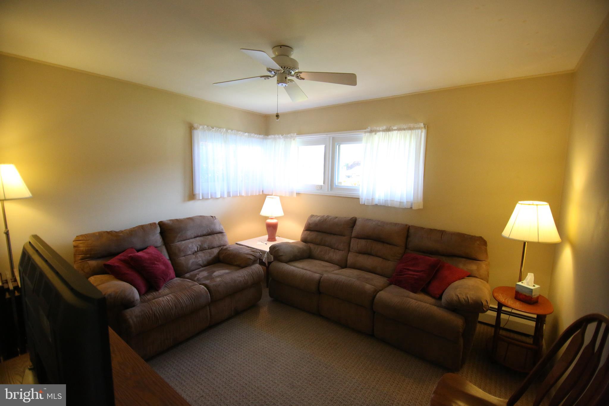 47 Trellis Road Levittown, PA 19056 - Photo 14 of 34 a living room with furniture and a lamp