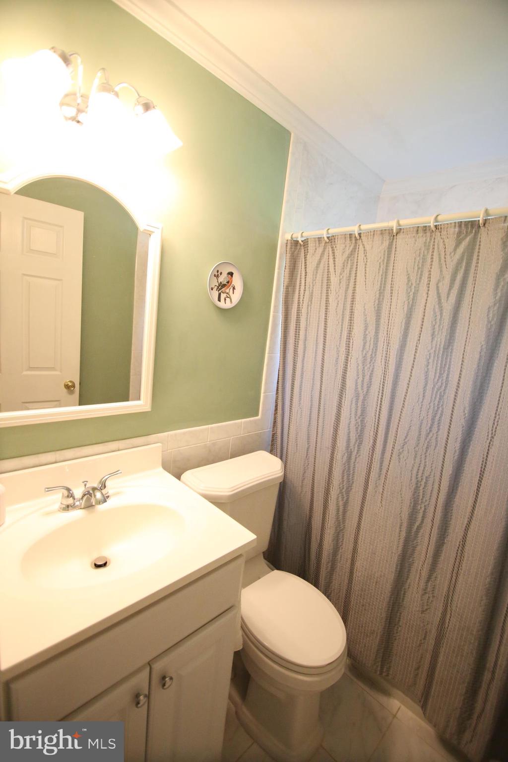 47 Trellis Road Levittown, PA 19056 - Photo 16 of 34 a bathroom with a sink and a mirror