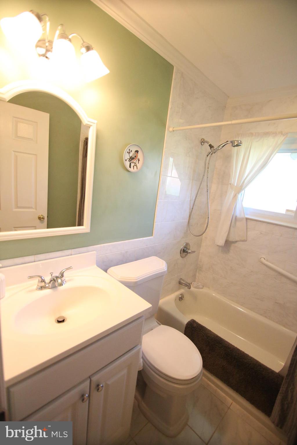 47 Trellis Road Levittown, PA 19056 - Photo 17 of 34 a bathroom with a sink and a mirror
